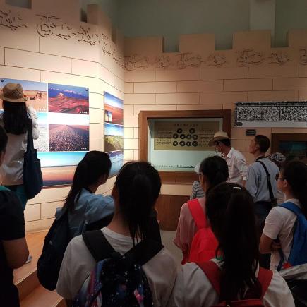 Students listened carefully to the tour-guide’s explanation of the  Yangguan Historic Sites